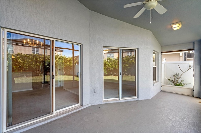 unfurnished sunroom featuring lofted ceiling and ceiling fan