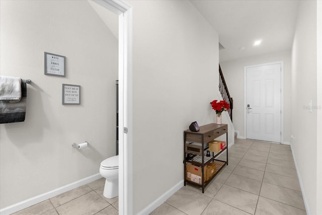 corridor with light tile patterned flooring