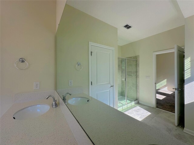 full bathroom featuring a stall shower, visible vents, and vanity