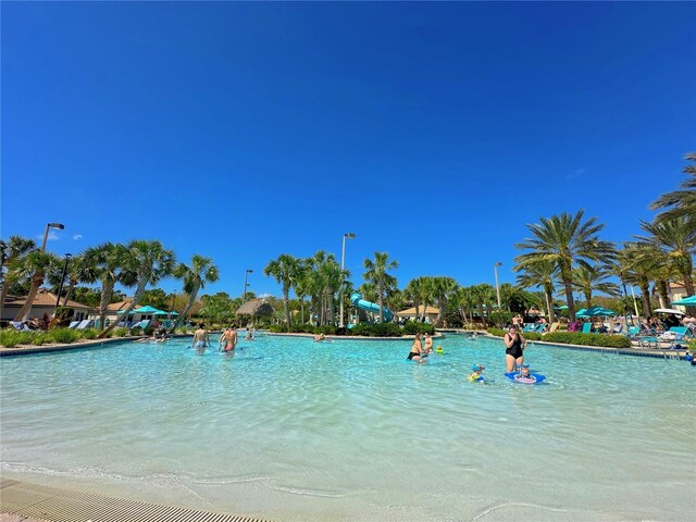 view of swimming pool featuring a water view