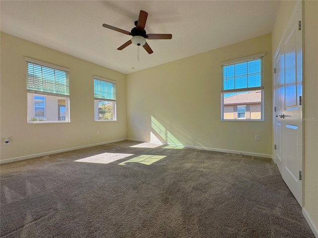 empty room with ceiling fan, baseboards, and carpet flooring