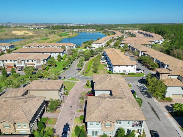 birds eye view of property with a water view and a residential view