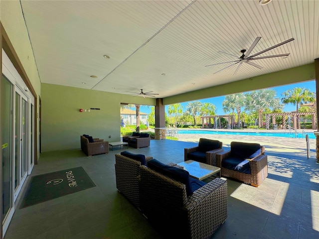 view of patio with ceiling fan, a community pool, and an outdoor living space