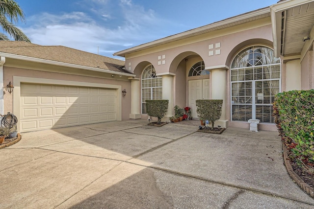 view of exterior entry with a garage