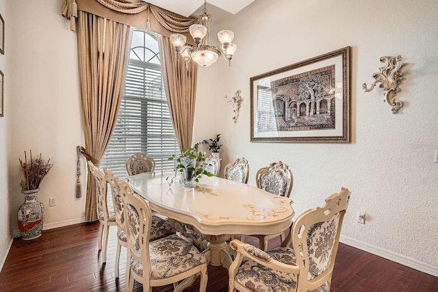 dining room featuring dark hardwood / wood-style floors and an inviting chandelier