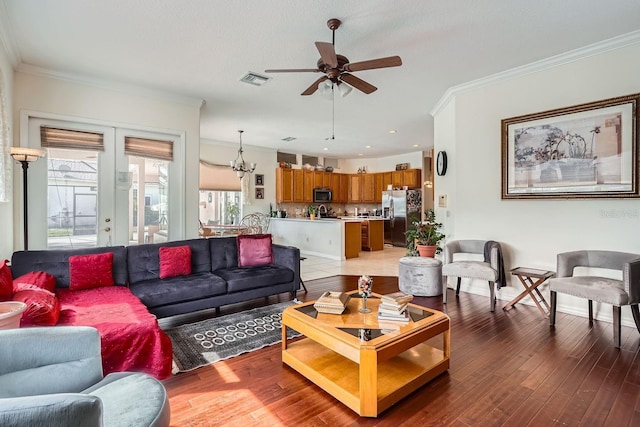 living room featuring french doors, ornamental molding, and hardwood / wood-style flooring