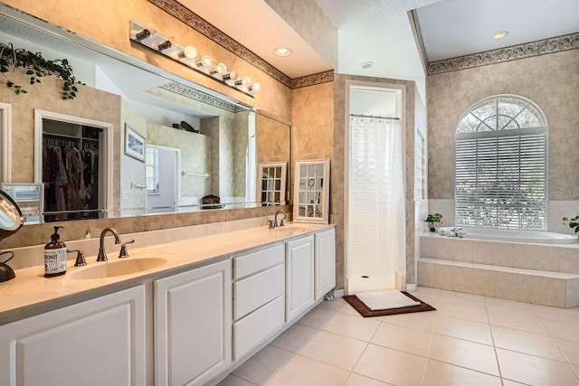 bathroom featuring vanity, tile patterned floors, and plus walk in shower