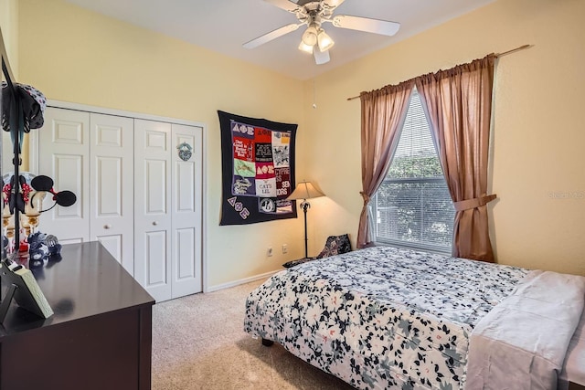 bedroom featuring light colored carpet, ceiling fan, and a closet