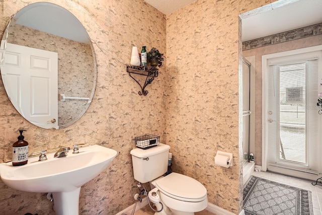 bathroom with tile patterned flooring, sink, and toilet