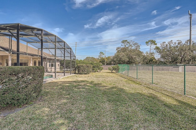 view of yard with a swimming pool and glass enclosure