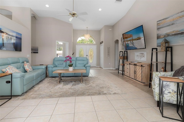 tiled living room featuring a towering ceiling and ceiling fan