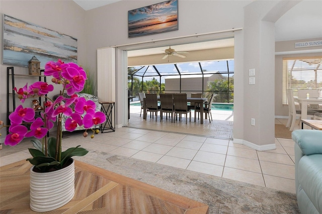 interior space featuring light tile patterned floors, a healthy amount of sunlight, and ceiling fan