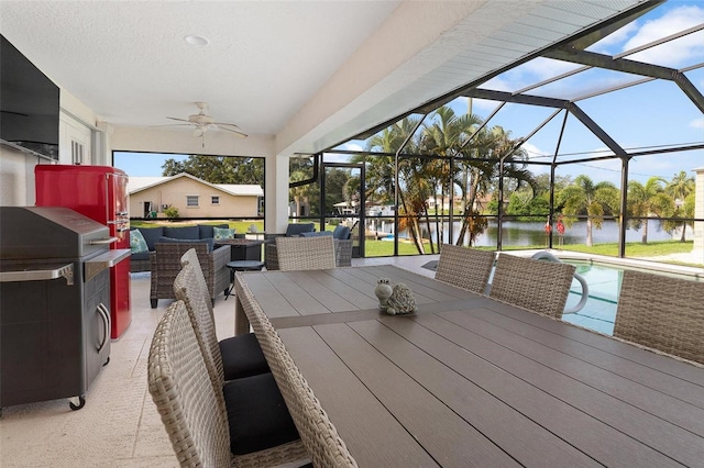 wooden deck with a water view, an outdoor hangout area, glass enclosure, and a patio area