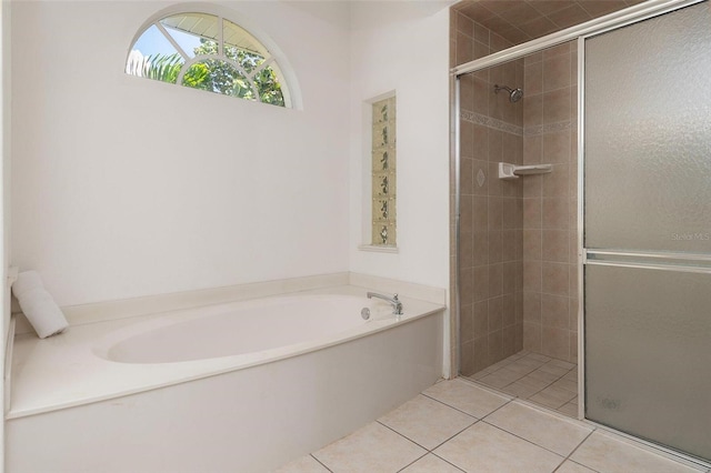 bathroom with separate shower and tub and tile patterned flooring