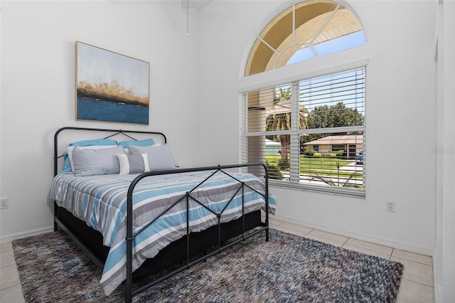 bedroom featuring tile patterned flooring and multiple windows