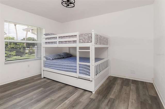 unfurnished bedroom with dark wood-type flooring