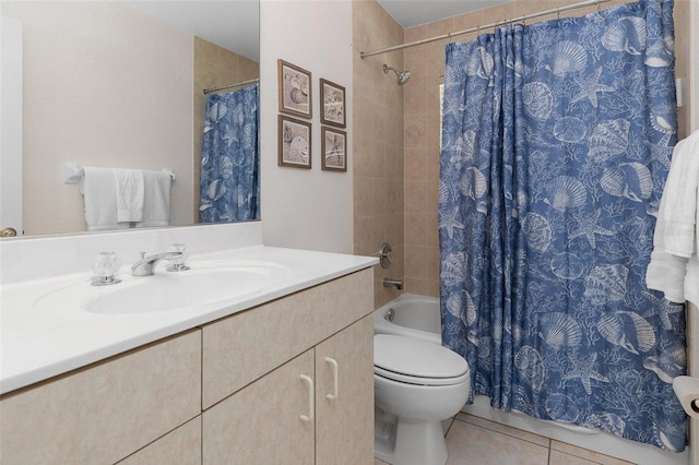 bathroom with tile patterned flooring, vanity, and toilet