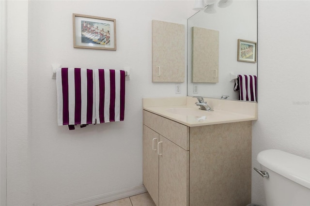 bathroom featuring tile patterned flooring, vanity, and toilet