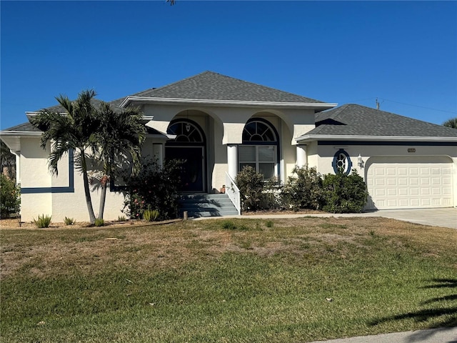 view of front of property with a garage and a front lawn