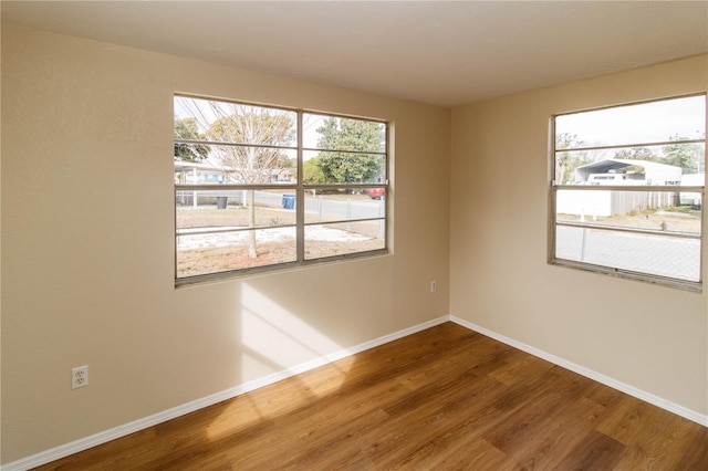 unfurnished room featuring wood finished floors and baseboards