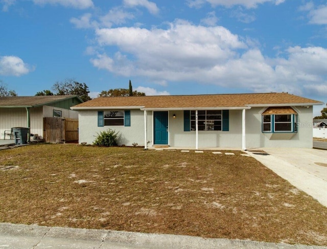 ranch-style house with a front yard, fence, and stucco siding