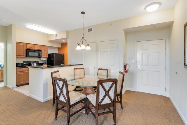 carpeted dining room featuring a chandelier