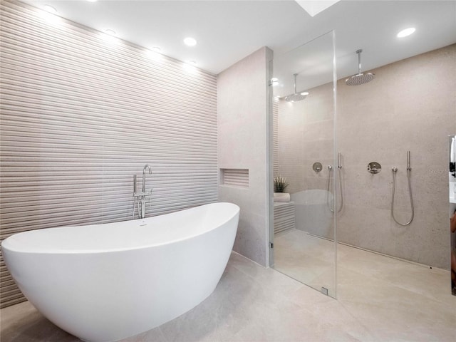 bathroom with plus walk in shower, tile walls, and tile patterned floors