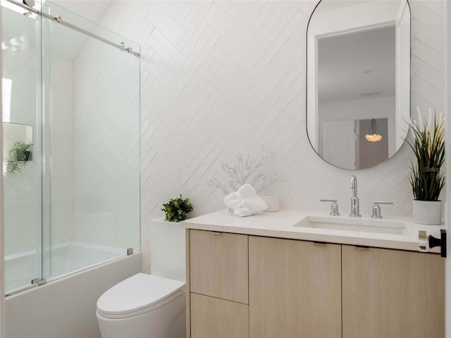 full bathroom with enclosed tub / shower combo, tile walls, vanity, decorative backsplash, and toilet