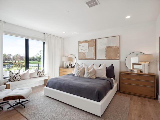 bedroom with hardwood / wood-style flooring