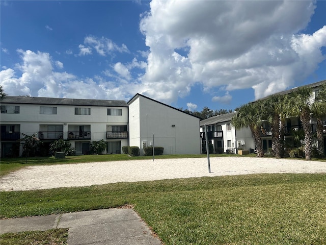 view of community with a yard and volleyball court