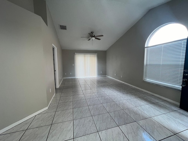 empty room with lofted ceiling and ceiling fan