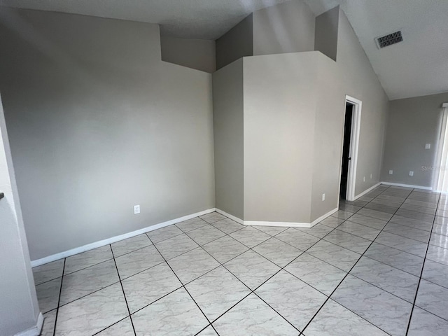 unfurnished room featuring high vaulted ceiling