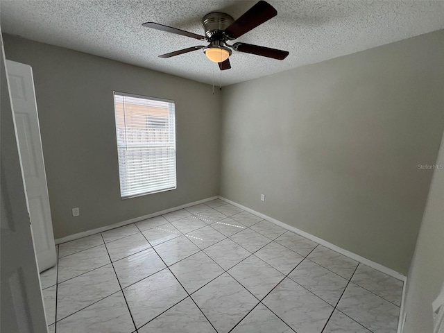 spare room featuring ceiling fan and a textured ceiling