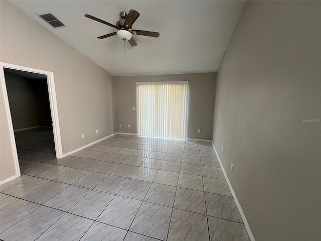 empty room featuring lofted ceiling and ceiling fan