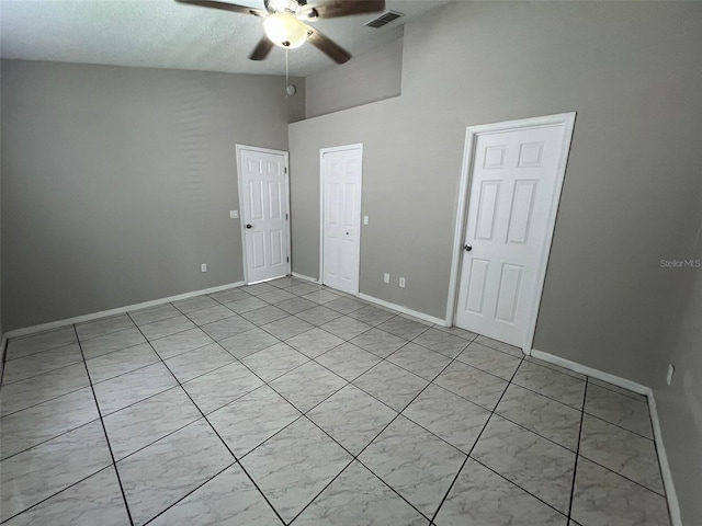 empty room featuring high vaulted ceiling and ceiling fan