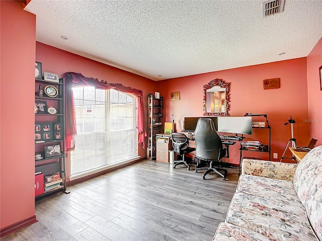 office area featuring hardwood / wood-style floors and a textured ceiling