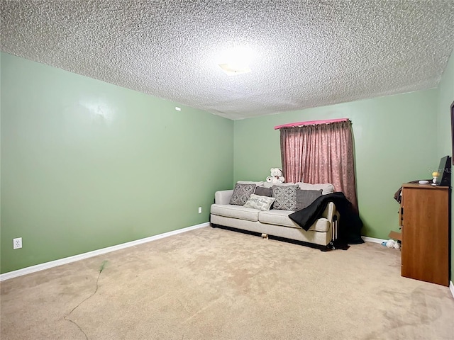 sitting room featuring a textured ceiling and carpet