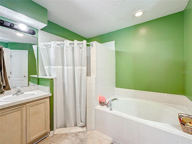 bathroom with vanity, tile patterned flooring, plus walk in shower, and a textured ceiling