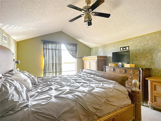 bedroom featuring vaulted ceiling, carpet floors, ceiling fan, and a textured ceiling