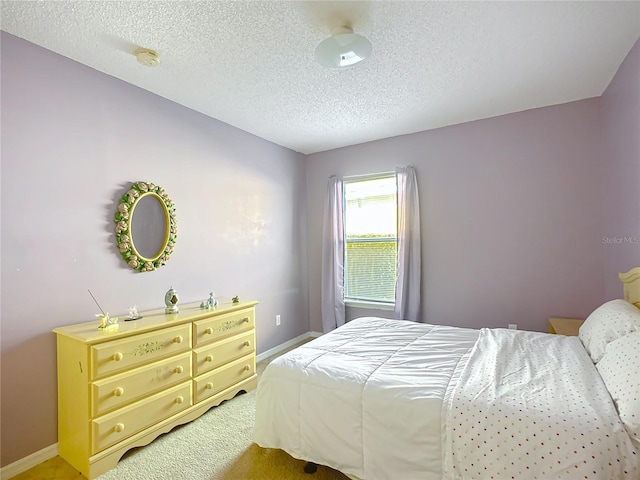 bedroom featuring carpet floors and a textured ceiling