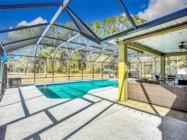 view of swimming pool featuring a patio, a lanai, central AC, and ceiling fan