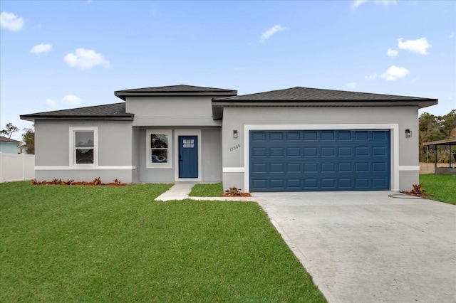 prairie-style house featuring a front yard, concrete driveway, an attached garage, and stucco siding