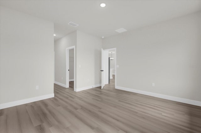 empty room with light hardwood / wood-style flooring