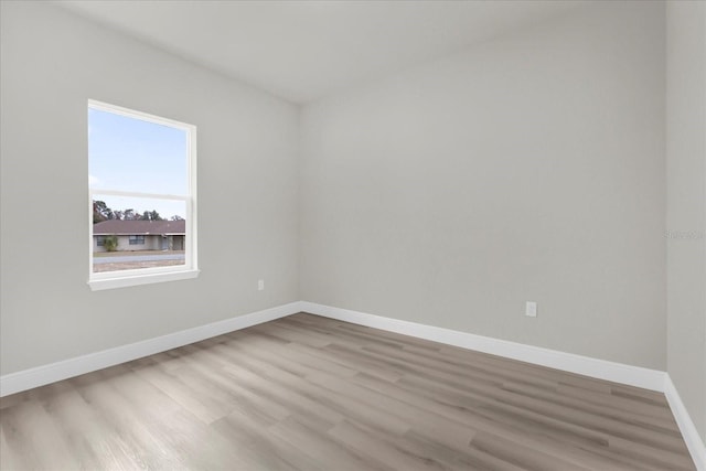 unfurnished room featuring baseboards and wood finished floors