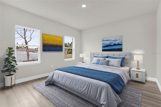 bedroom with multiple windows, recessed lighting, light wood-style flooring, and baseboards