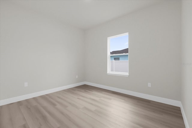 empty room with wood finished floors and baseboards