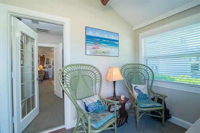 living area with lofted ceiling and carpet