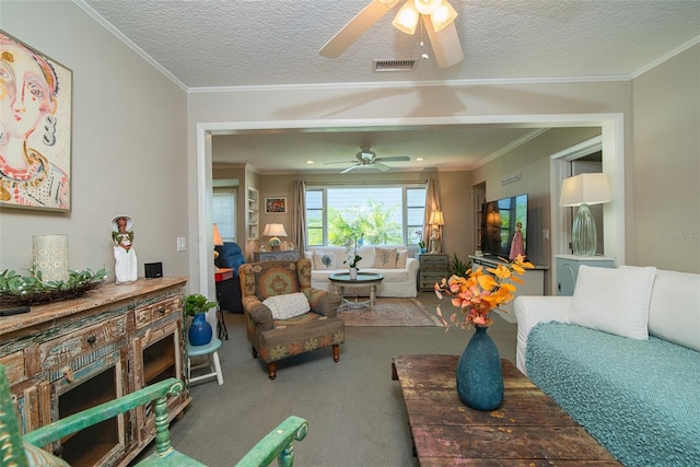 carpeted living room with ceiling fan, crown molding, and a textured ceiling