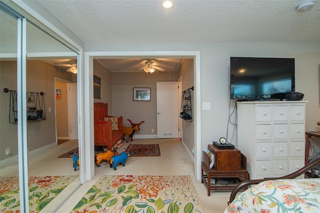 bedroom with a textured ceiling and ceiling fan