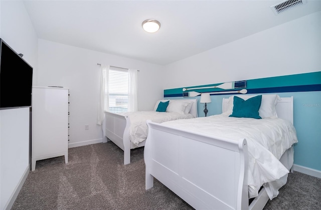 bedroom with dark colored carpet